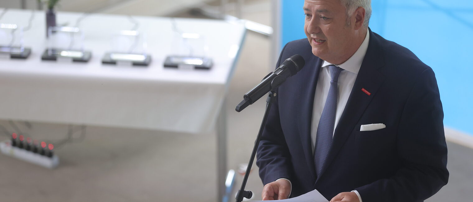 HWK-Präsident Matthias Graßmann spricht in ein Mikrofon.