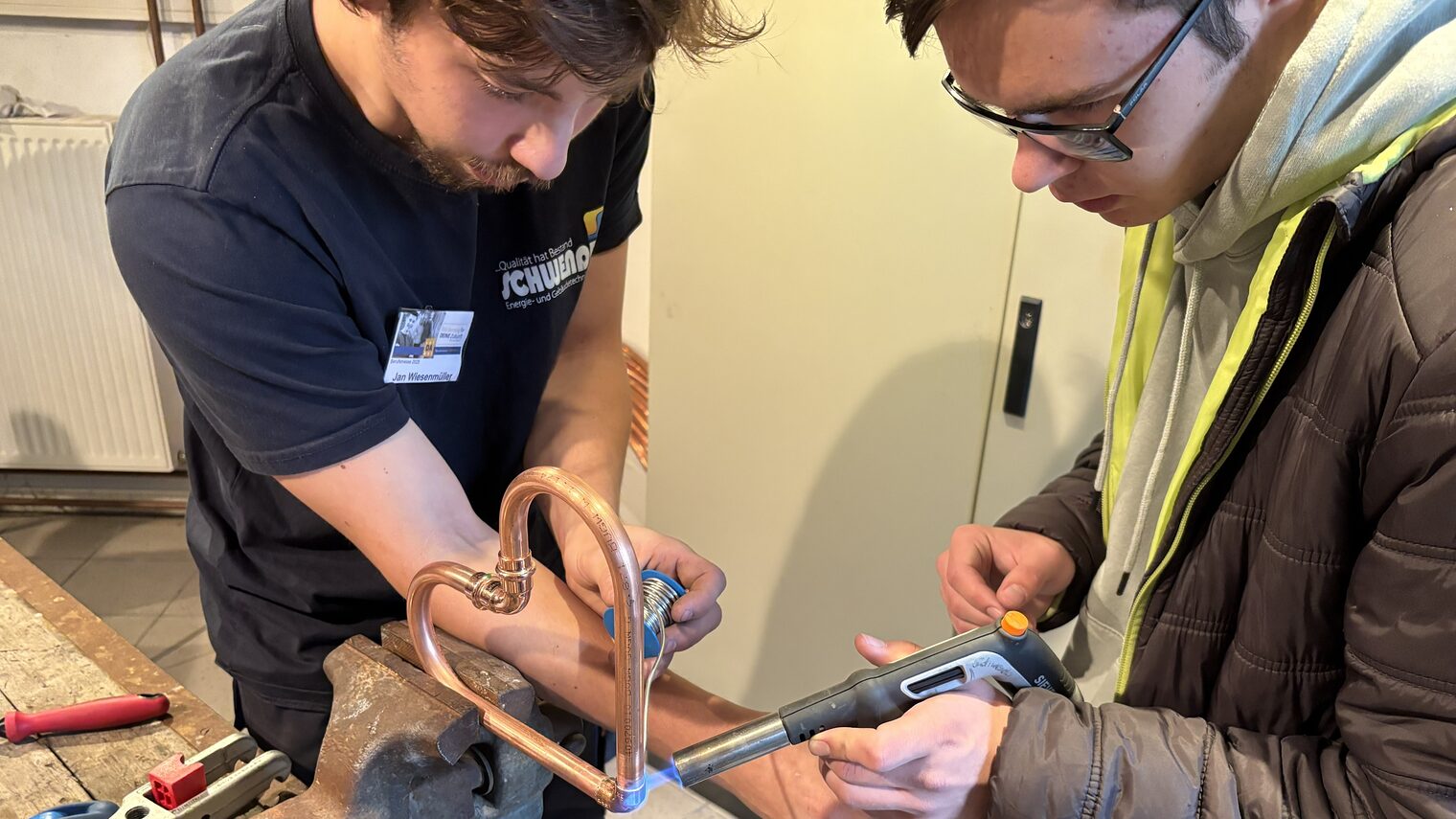 Stefan Kolb trägt eine VR-Brille und zeigt das Verkabeln eines Verteilerkastens am Bildschirm.