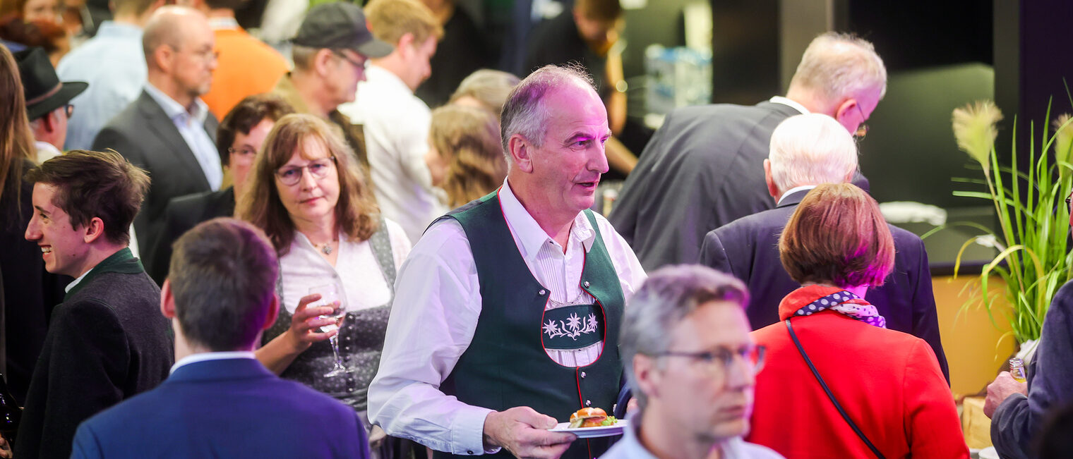Die Gäste der Landessiegerfeier stehen im Catering-Bereich.