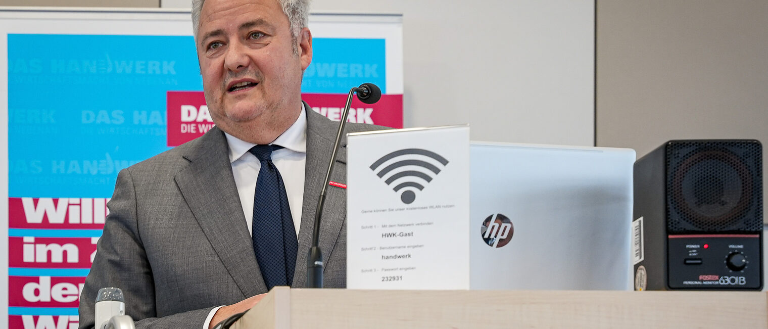 HWK-Präsident Matthias Graßmann hält eine Rede am Rednerpult.