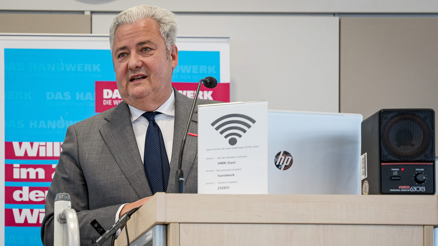 HWK-Präsident Matthias Graßmann hält eine Rede am Rednerpult.