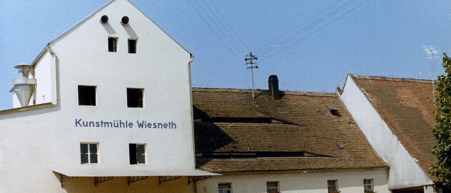Historisches Bild der Außenansicht des Gebäudes der Kunstmühle Wiesneth aus den 1980ern