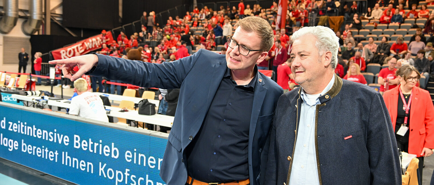 David Silasi erklärt HWK-Geschäftsführer Matthias Graßmann etwas am Spielfeldrand. 