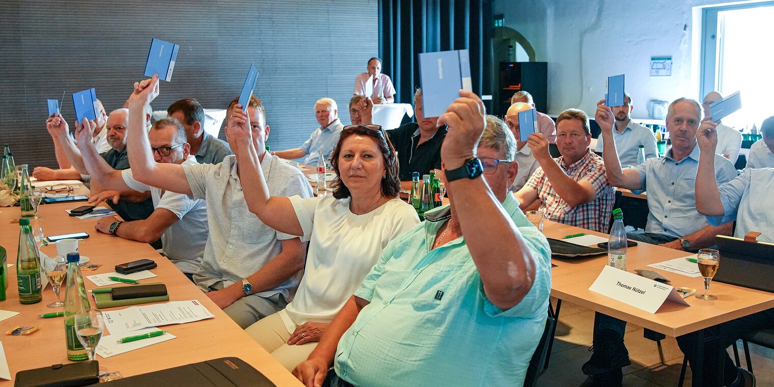 Die Mitglieder der Vollversammlung stimmen mit Abstimmkarten ab.