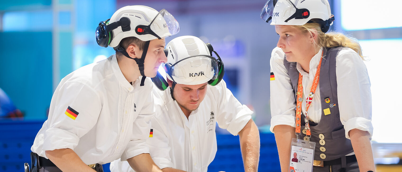 Jakob Distler und Tim Arnold besprechen sich mit Bundestrainerin Jule Janson.