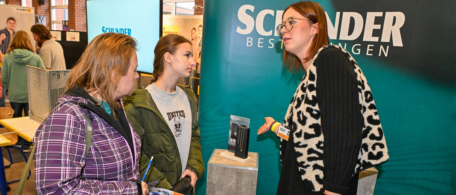 Zwei Jugendliche informieren sich an einem Stand von Schunder Bestattungen.